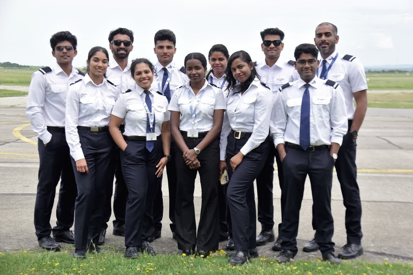 TATS cadets in uniform standing together on the airfield